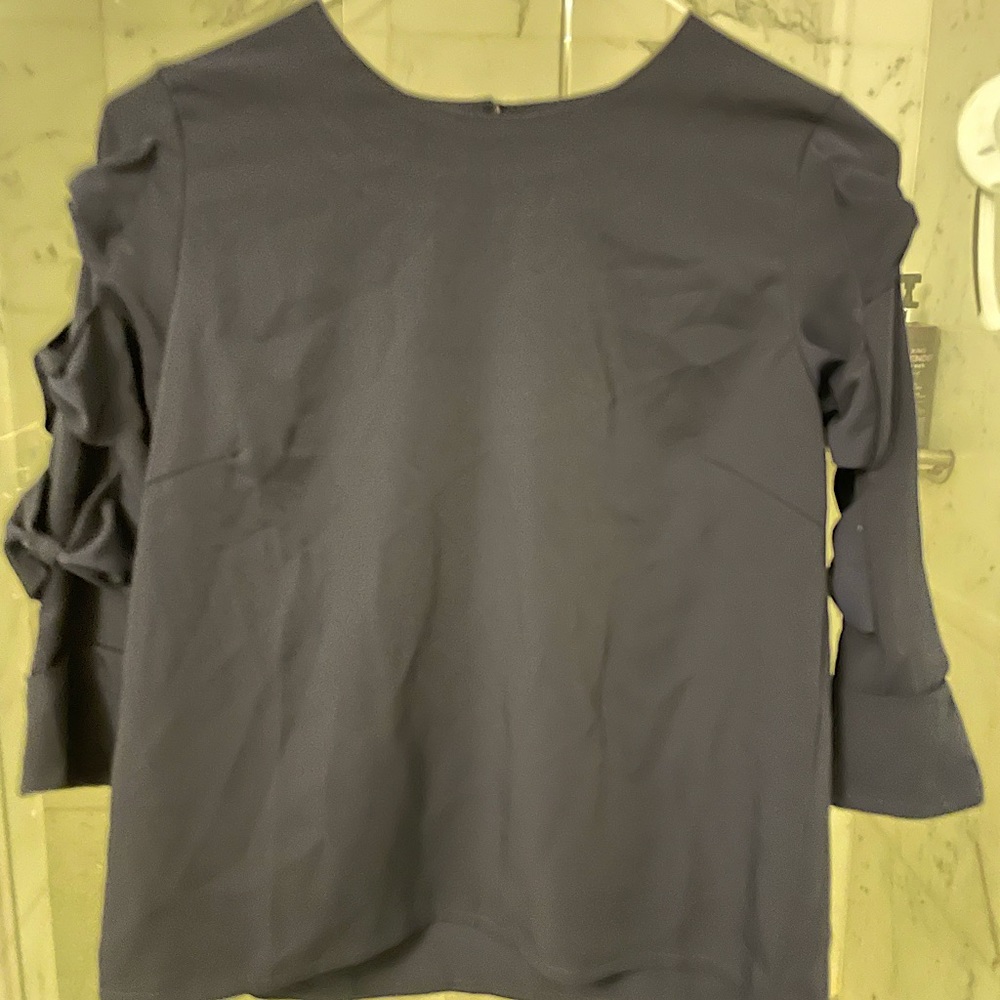 Brand new navy top with bow details on sleeve.